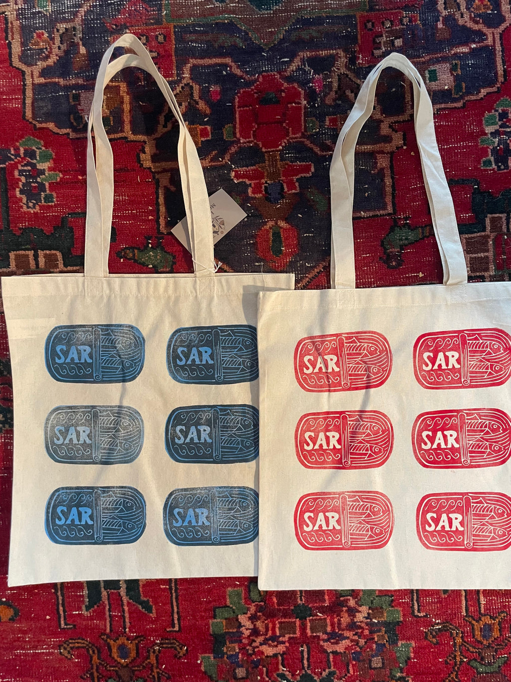 Blue and red sardine tote bags